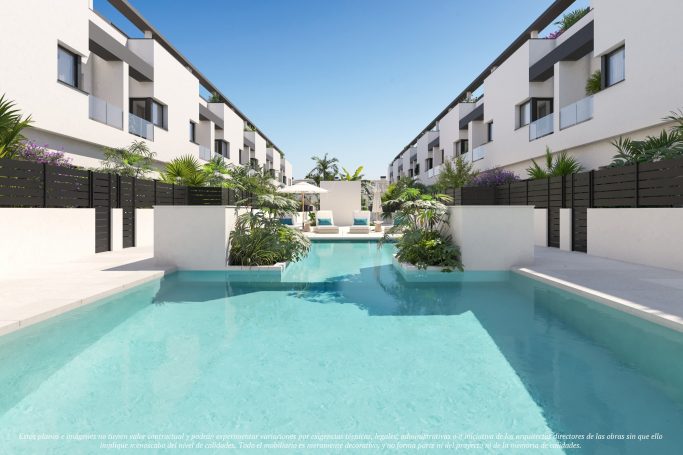 Venta de parcela para construir 41 viviendas en Mutxamel, Alicante Vista de una piscina rodeada de edificios modernos y vegetación.